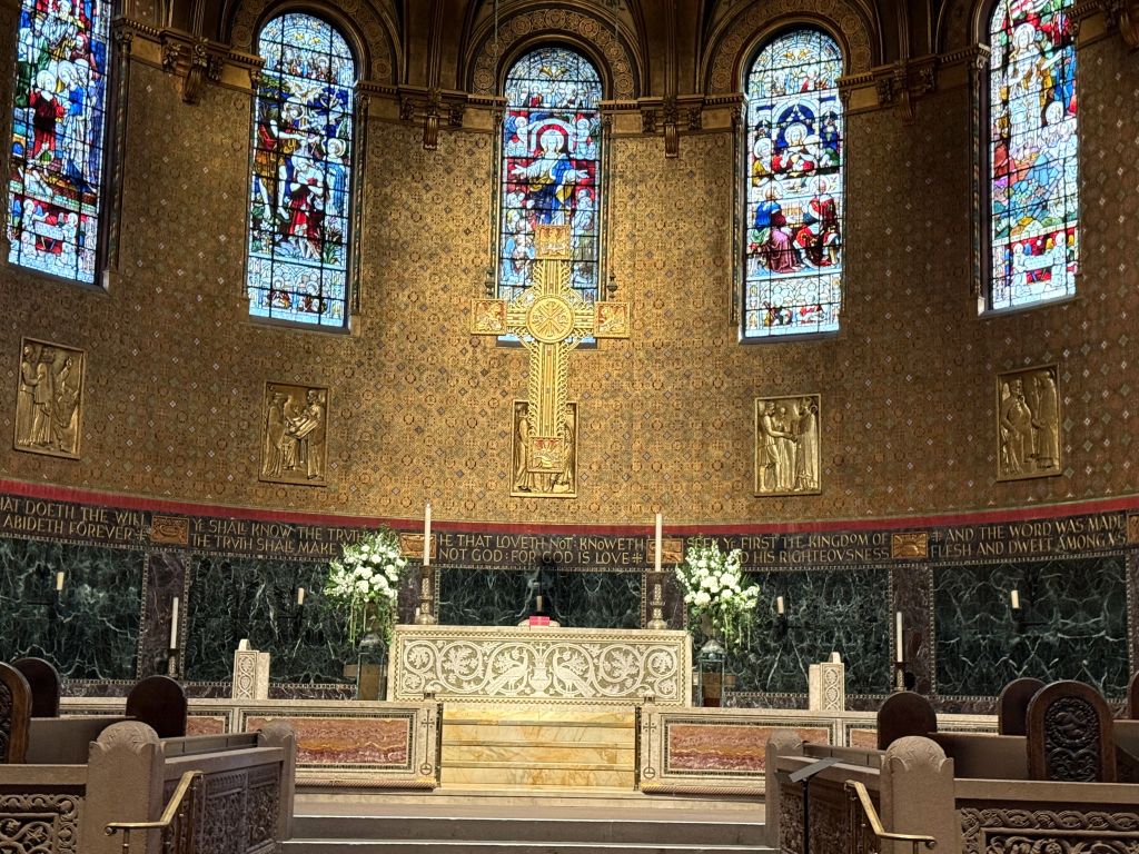 Stunning stained-glass windows inside Trinity Church in Copley Square, Boston, softly glowing in the morning light during my New England fall travel story.