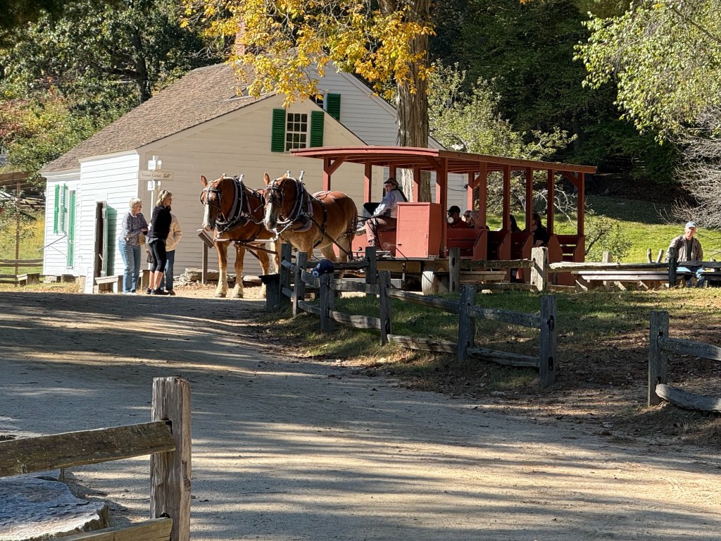 Horse-drawn carriage ride at Old Sturbridge Village during our New England Fall Coastal Trip